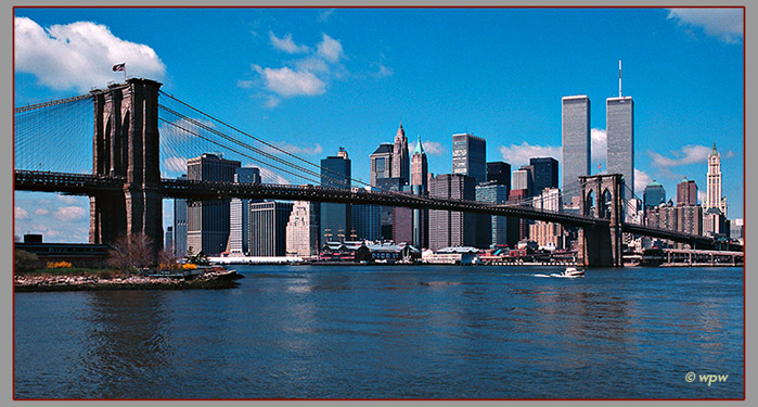 <Photo by Wolf Peter Weber of the Brooklyn Bridge with World Trade Center in background.>