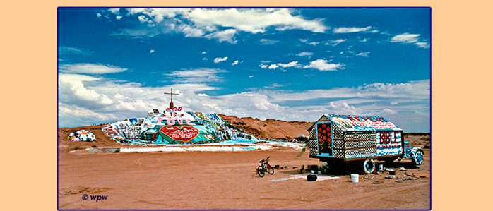 <Panorama photo by Wolf P. Weber depicting front view of Salvation Mountain and Leonard Knight's Parading Truck>